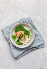 scallop risotto with asparagus, spinach in rustic plate on marble background with copy space