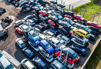 Lines of crushed cars wreck in scrapyard before being shredded recyling