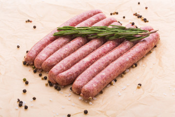 Food and delicious concept - raw horse meat sausage