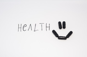 A smiling face of medical black pills 