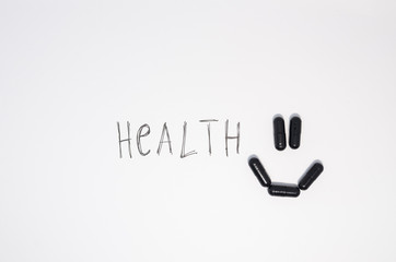 A smiling face of medical black pills 