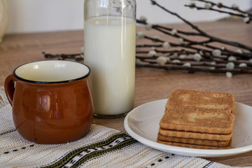 Light snack - milk, cup, saucer with cookies.
