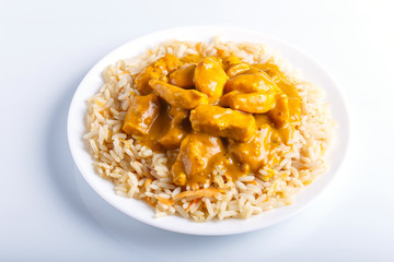 Rice with chicken curry sauce with cashew isolated on white background.