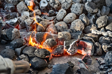 Charcoal on the grill starts to glow