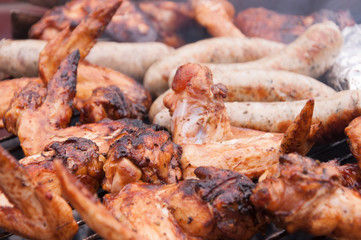 Hot wings with sausages on the grill