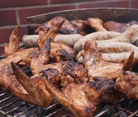 Hot wings with sausages on the grill