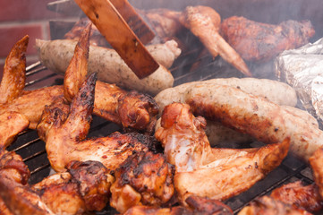 Hot wings with sausages on the grill