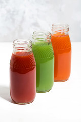 colorful vegetable juices in bottles, vertical top view
