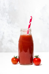 fresh tomato juice in a bottle, vertical