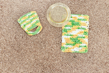 Fototapeta na wymiar Summer items - sun hat, bag, towel on sandy beach. Summer background. Copy space.