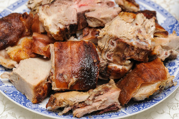 Pig roast with golden skin served on plate. Pig roast. Protein sourse. Meat lunch