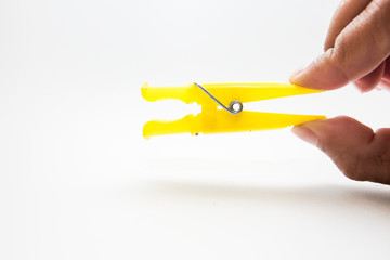 Hand holding a clothespin isolated On a white background 