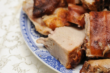 Pig roast with golden skin served on plate. Pig roast. Protein sourse. Meat lunch