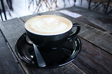 A cup of coffee at the eye view on wood table