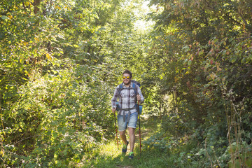 Obraz premium People, hike, tourism and nature concept - Man in the forest
