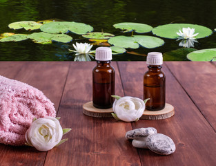 Aromatherapy oils, small stones, pink towel