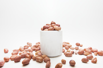 Peanuts in small cups isolated on white background