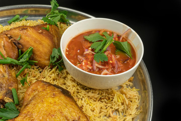 chicken mandy rice set with spicy sauce and salad isolated on dark background