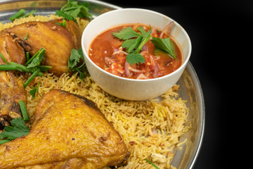 chicken mandy rice set with spicy sauce and salad isolated on dark background