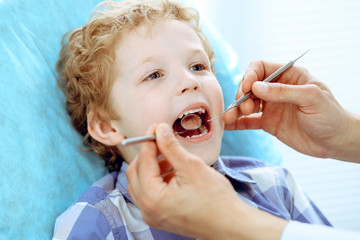 Doctor and patient child. Boy having his teeth examined with dentist. Medicine, health care and stomatology concept