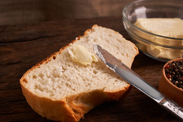Bakery - gold rustic crusty loaves of bread and buns on black chalkboard background. Still life captured from above