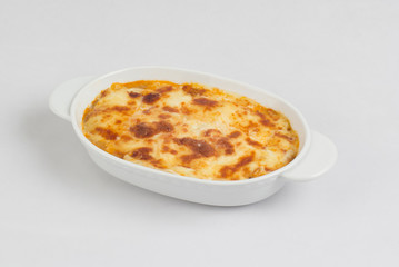 Lasagna in baking dish isolated on white