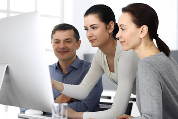 Group of business people discussing questions at meeting in modern office. Headshot at negotiation or workplace. Teamwork, partnership and business concept 