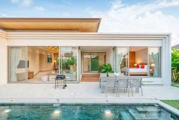 home or house Exterior design showing tropical pool villa with greenery garden, sun bed, umbrella,...