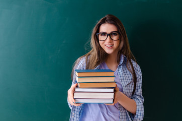 Female student in front of chalkboard 