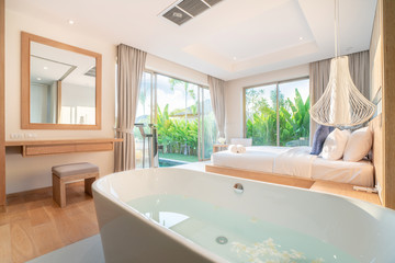 real Luxury Interior design in bedroom of pool villa with cozy king bed with high raised ceiling home, house ,building