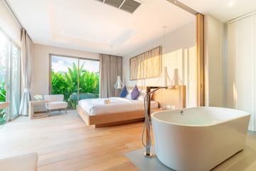real Luxury Interior design in bedroom of pool villa with cozy king bed with high raised ceiling home, house ,building