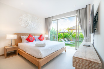 real Luxury Interior design in bedroom of pool villa with cozy king bed with high raised ceiling home, house ,building