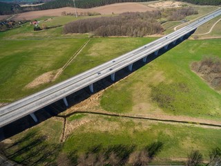 highway bridge in rural area - aerial view of a big highway bridge in rural area in germany european - cars drive over the highway bridge - drone flight
