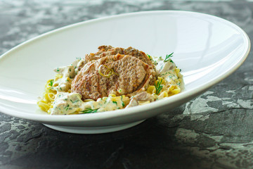 roast meat, pasta fine Annellini and creamy sauce (main dish). food background. top view