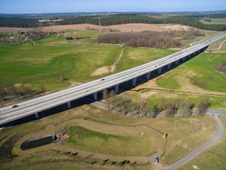 highway bridge in rural area - aerial view of a big highway bridge in rural area in germany european - cars drive over the highway bridge - drone flight