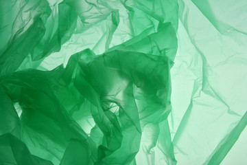 Plastic bag concept. Polyethylene as smoke may use as background. Emerald green textured gradient. Background for design. Template for card, poster, banner design.