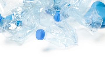 Crumpled empty single-use plastic cups and bottles, studio shot.  Plastic pollution concept. Single-use plastic is a human addiction that is destroying our planet 