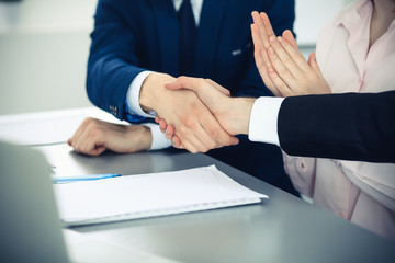 Business people shaking hands finishing up a meeting. Handshake at successful negotiation