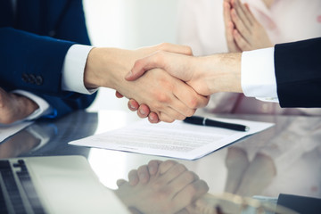 Business people shaking hands finishing up a meeting. Handshake at successful negotiation