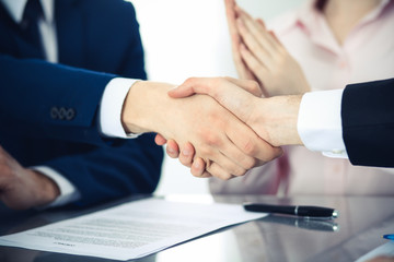 Fototapeta premium Business people shaking hands finishing up a meeting. Handshake at successful negotiation