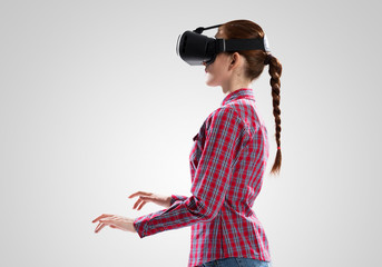 Girl in mask experiencing virtual reality as new entertainment device