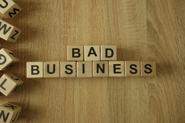 Bad business text from wooden blocks on desk