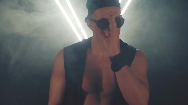 Sexy man dancing in smoke