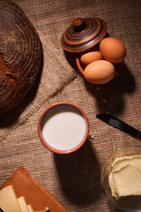 Assorted dairy products milk, cheese, butter rustic still life on table