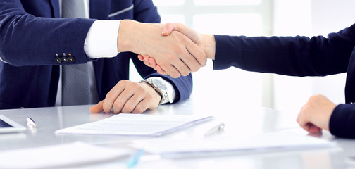 Group of business people or lawyers shaking hands finishing up a meeting , close-up. Success at negotiation and handshake concepts