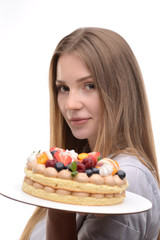 baker girl with a cake with berries on a white background