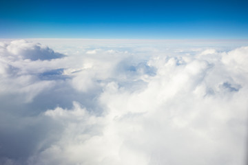 Impressive cloudscape with white clouds beneath