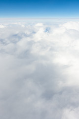 Impressive cloudscape with white clouds beneath