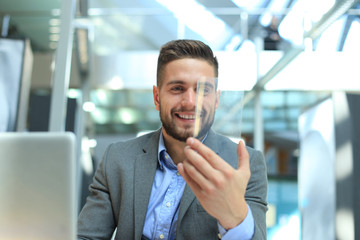 Future concept. Businessman holds futuristic transparent smart phone.