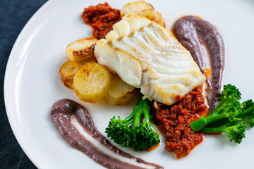 Cod loin with black olives puree and sundried tomatoes